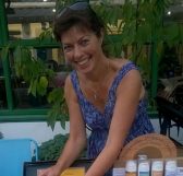 Customer Caro's Creams Smiling woman behind a stall selling cosmetic products